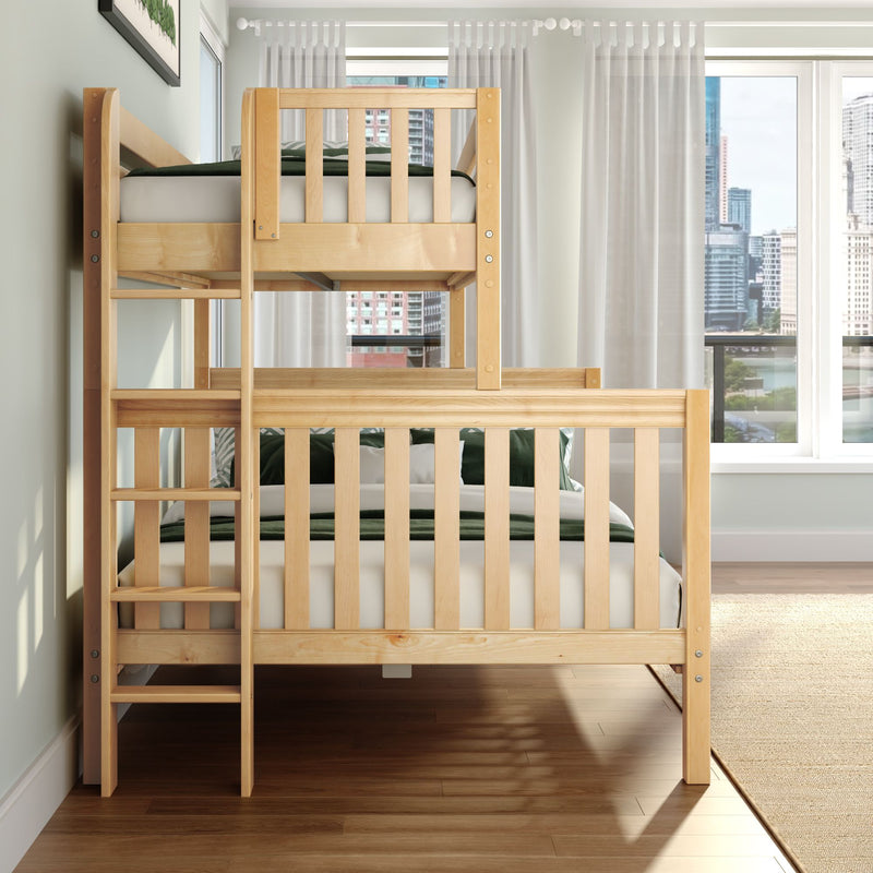 Modern natural pine twin-over-twin bunk bed with ladder and green bedding in a bright kids' bedroom with sheer curtains, hardwood floors, and a city skyline view