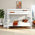 White loft bunk bed with storage stairs and orange bedding in a modern space-saving kids' bedroom, framed autumn cityscape wall art and potted plant