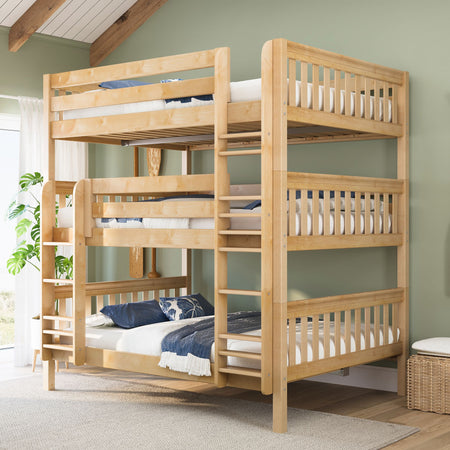 Solid wood triple bunk bed with ladder and twin mattresses in light natural finish, styled in a space-saving kids' bedroom with green wall and blue linens