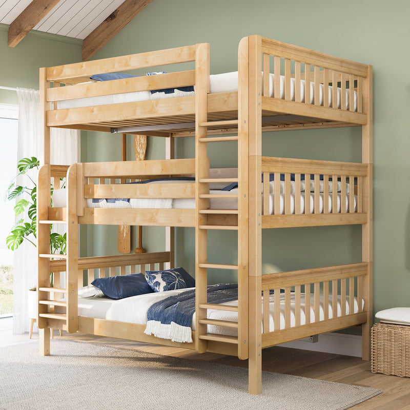 Solid wood triple bunk bed with ladder and twin mattresses in light natural finish, styled in a space-saving kids' bedroom with green wall and blue linens