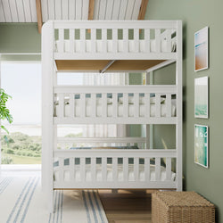 White wooden triple bunk bed in coastal kids bedroom with green walls, beach view, framed art and wicker storage