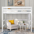 White twin loft bed over cozy reading nook with beige armchair and yellow pillow, round white side table, potted plant and abstract wall art