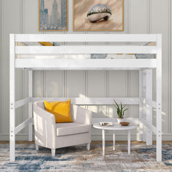 White wooden loft bed with beige armchair and yellow accent pillow underneath, round white side table with potted plant and modern wall art
