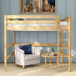 Light wood loft bed with ladder over cozy beige armchair and round side table with potted plant against blue paneled wall, modern small-space bedroom interior