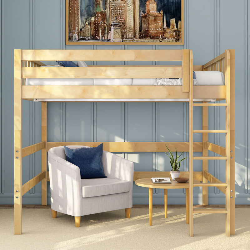 Light wood loft bed with ladder over cozy beige armchair and round side table with potted plant against blue paneled wall, modern small-space bedroom interior