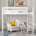 White loft bed with ladder over a cozy seating nook, beige armchair with yellow pillow, round side table and plant — modern small-space bedroom furniture
