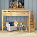 Light wood loft bed with built-in stairs over a cozy reading nook — gray armchair, round wooden side table and potted plant against a blue paneled accent wall, space-saving modern bedroom furniture