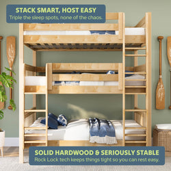 Solid hardwood triple bunk bed with built-in ladders and safety rails in coastal-themed guest room — space-saving, sturdy sleeping solution for kids and guests