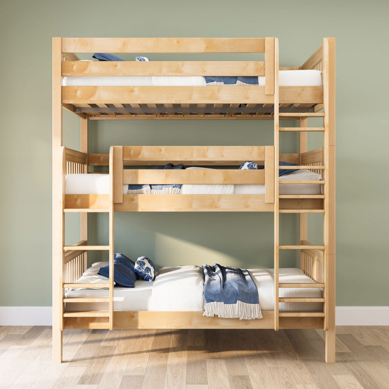 Light natural wood triple bunk bed with ladders, white mattresses and blue bedding in a space-saving modern kids' bedroom with sage green wall and hardwood floor