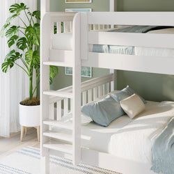 White wooden bunk bed in sunlit kids' bedroom with soft blue bedding, space-saving ladder, green accent wall and potted monstera plant