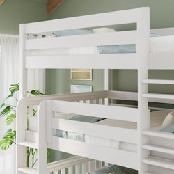 White wooden triple bunk bed with ladder in modern kids bedroom, light blue bedding, green accent wall and potted plant
