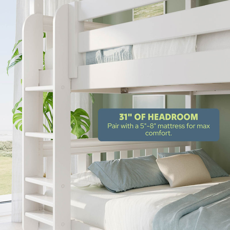 White wooden bunk bed with ladder and 31-inch headroom, lower bed with teal pillows and beige cushion in sunlit green bedroom with plant, space-saving bunk bed