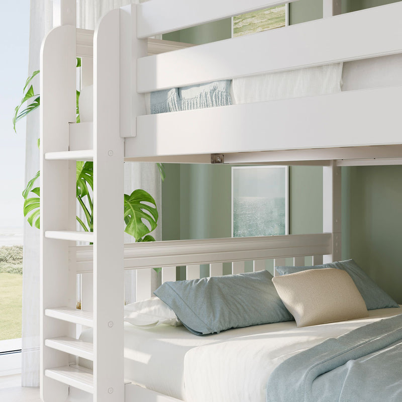 White wooden bunk bed with teal bedding and ladder in a coastal-inspired bedroom featuring an indoor plant and ocean artwork