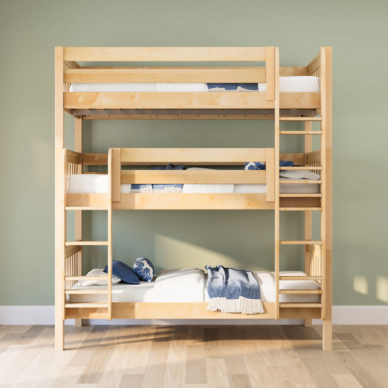 Light maple triple bunk bed with ladders, white mattresses and blue throws in a space-saving kids bedroom with sage green wall