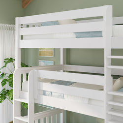 White wooden twin-over-twin bunk bed with ladder in a green kids' bedroom, coastal artwork, sheer curtains and potted plant.