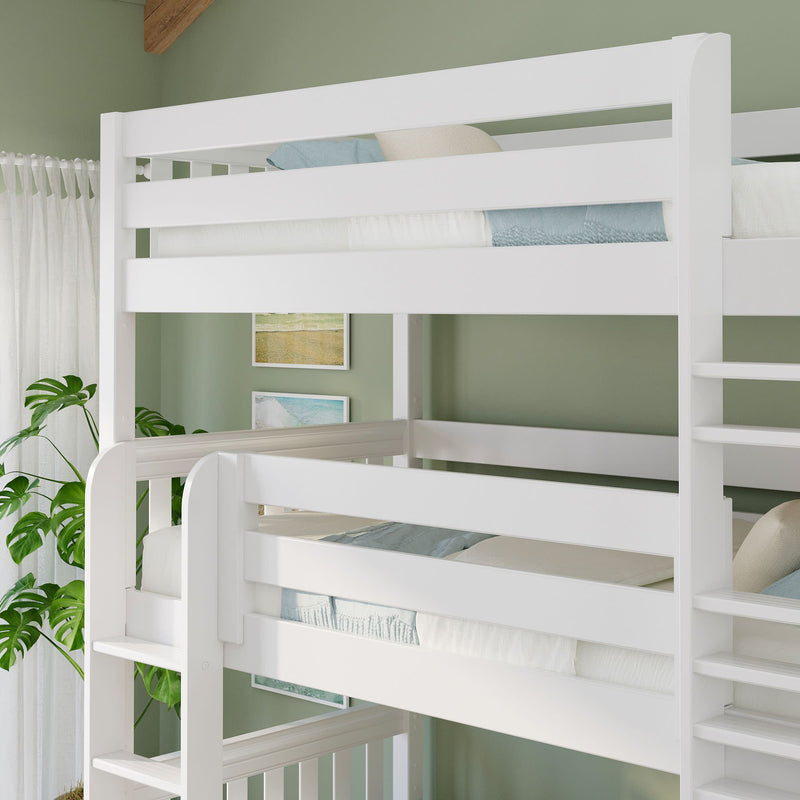 White wooden twin-over-twin bunk bed with ladder in a green kids' bedroom, coastal artwork, sheer curtains and potted plant.