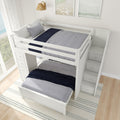 White bunk bed with built-in staircase and storage drawers in a bright bedroom.