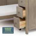 Wooden dresser drawers open next to a bed, showcasing seamless storage furniture design.