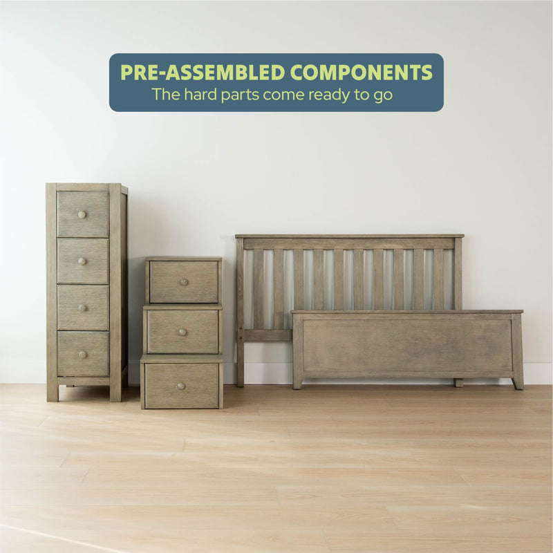 Pre-assembled bedroom furniture components including a dresser, nightstands, and bed frame on a wooden floor.
