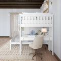 Modern white loft bed with integrated desk, stylish chair, and decorative lamp in a cozy bedroom setting.