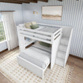 White loft bed with stairs in a cozy, light-filled bedroom featuring blue striped wallpaper.