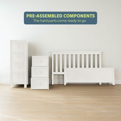 Pre-assembled white bedroom furniture including a tall dresser, stacked drawers, and a bed frame on a light wooden floor.