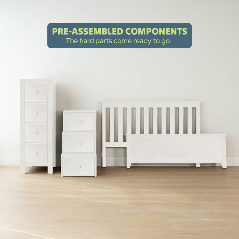 Pre-assembled white bedroom furniture including a tall dresser, stacked drawers, and a bed frame on a light wooden floor.