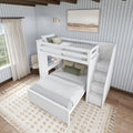 White twin loft bed with storage steps in a cozy bedroom with light blue striped wallpaper and decorative rug.