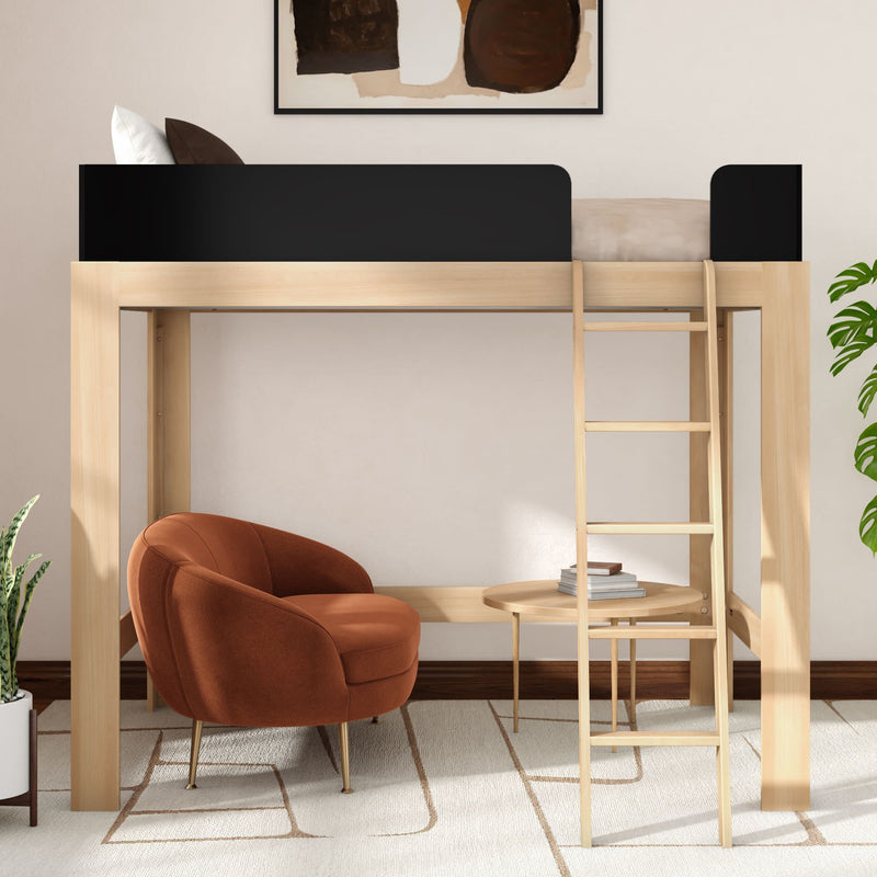 Modern light-wood loft bed with ladder and black guardrail above a cozy rust-orange upholstered lounge chair, round wooden side table with books, potted plant and abstract wall art — small-space bedroom loft bed reading nook