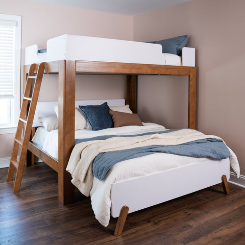 Modern wooden loft bunk bed with ladder, white guard rails and blue-beige bedding in a neutral kids' bedroom