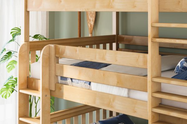Wooden bunk bed with white bedding and blue pillows in a room with plants.