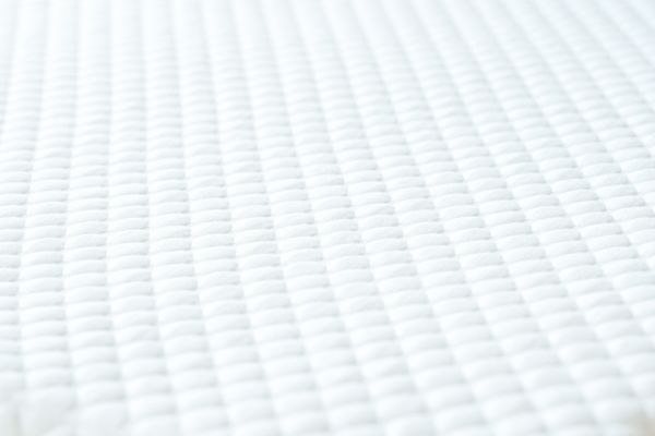 Close-up of white woven fabric texture.