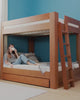 Video of women utilizing trundle, staircase, and features of the king over kind bunk bed.
