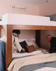 Adults relaxing and hanging out around their bunk beds for adults.